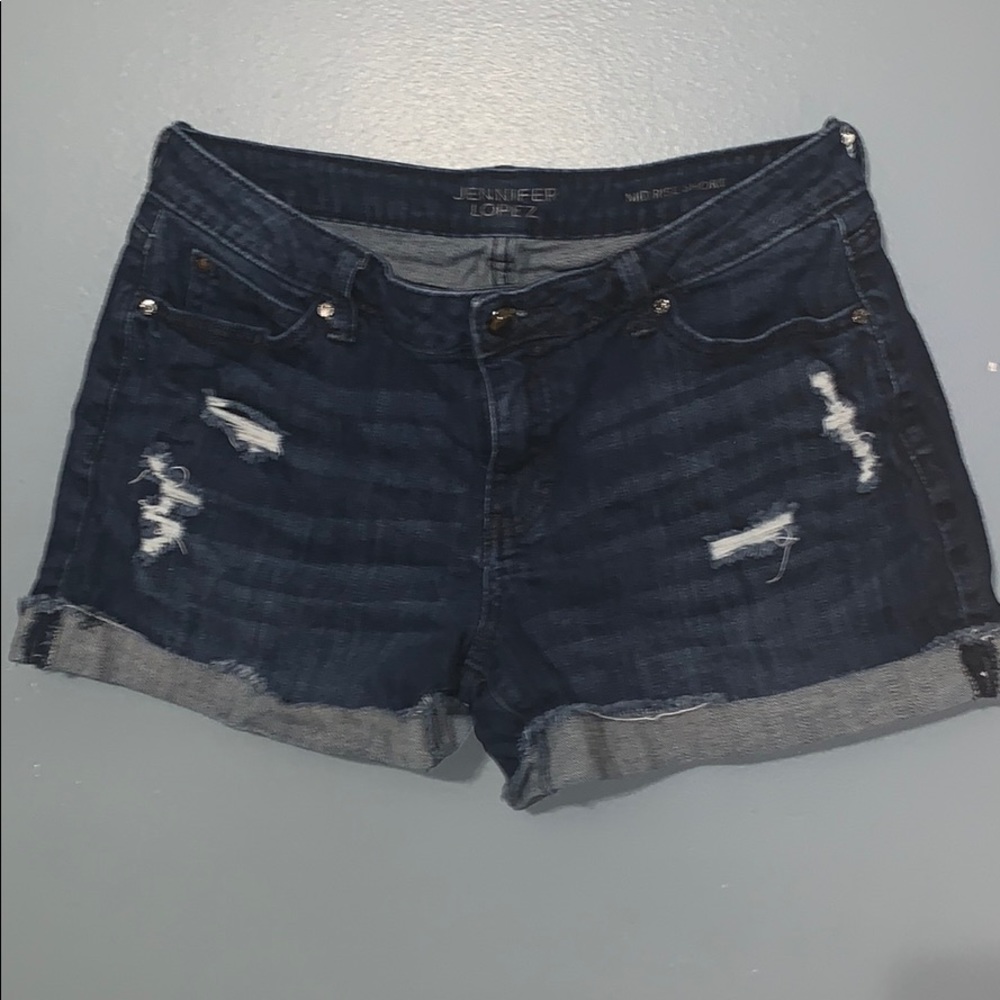 Jennifer Lopez mid rise blue jean shorts.